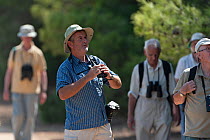 Group of birdwatchers with binoculars birdwatching, Sagres, Algarve, Portugal. October, 2018.