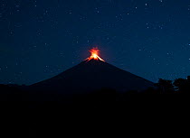 Lava erupting from Fuego volcano under a starry sky at night, viewed from Finca el Zapote, Escuintla, Guatemala. January 19th, 2023.
