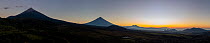 Panoramic view of Fuego, Agua and Pacaya volcanoes (from left to right) at sunrise, seen from Finca el Zapote, Guatemala. January, 2023.