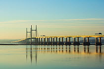 Prince of Wales (M4) bridge over the Severn Estuary at dusk, viewed from Severn Beach, South Gloucestershire, UK. February, 2023.