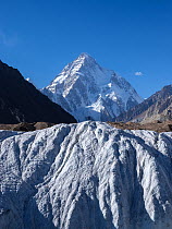 Godwin-Austen Glacier viewed from Baltoro Glacier and Concordia, with summit of K2 in background, Karakoram Mountains, Gilgit-Baltistan, Northern Pakistan. July, 2022.