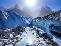 View of the confluence of Godwin-Austen and Baltoro Glacier in bright sunshine from Concordia, Gasherbrum IV, Karakoram Mountains, Gilgit-Baltistan, Northern Pakistan. July, 2022.