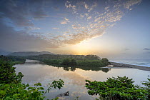 View over the Rio Piedras river mouth and surrounding forest around sunset, Tayrona National Park, Magdalena, Colombia. July, 2022.