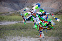 Gerimiah Holy Bull, a member of the Sioux Rosebud Tribe of Native Americans, wearing traditional dress performing a 'Fancy Dance', South Dakota, USA. June, 2022.