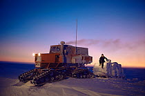 Snow-Cat tractor towing snow blocks to provide water for scientific base, Halley Research Station, Brunt Ice Shelf, Antarctica, August 1983.