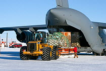 Cargo being offloaded from C17 Globemaster, ice runway, American McMurdo research station, Ross Island, Antarctica.