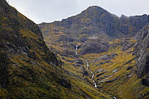 Mountain stream flowing down mountainside, Glencoe, Scotland, UK. October, 2022.