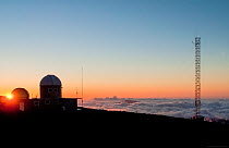 The National Oceanic and Atmospheric Administration's atmospheric and space observatory, at 3400 meters on the northeast flank of Mauna Loa volcano at sunset. Big Island, Hawaii. March, 2011.