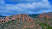 Panning timelapse of clouds moving over cliffs in Iregua Valley, Sierra Cebollera Natural Park, La Rioja, Spain. August.