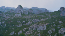 Panning timelapse of fog moving over rocky mountainside. The camera pans from right to left. Castros de Horneo, Collados del Ason Natural Park, Cantabria, Spain. July.