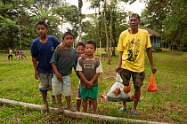 Children and man with live Chickens (Gallus gallus domesticus) in bag, Mindanao, Philippines, March 2007.