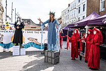 Street theatre representing Avara Cargill, a chicken processing factory company, on trial at Extinction Rebellion Save the Wye Campaign protest, Hereford, Herefordshire, UK, April 8th 2023.