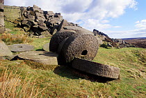 Abandoned millstones on rocky hillside, Peak District National Park, England, UK.