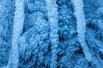 Icicles hanging from frozen Pericnik Waterfall, Triglav National Park, Julian Alps, Slovenia, February.