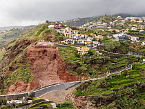 Landslide on cliffs above road with houses nearby, Ribiera Brava, Madeira. March, 2023.