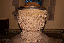 Depiction of Christ rescuing fallen Adam with 'Sacred Bird' perched on his shoulder on Eardisley Font, carved in the mid 12th century in the Romanesque style, Herefordshire, England, UK.
