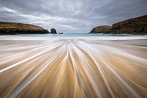 Traigh Dhail Beag / Dalbeg beach with long exposure showing water movement over sand, Isle of Lewis, Outer Hebrides, Scotland, UK. March, 2023.