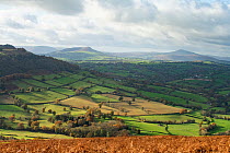 The Skirrid and  Sugar Loaf Mountain in Brecon Beacons National Park, Wales, viewed from Garway Hill, Herefordshire, England, UK, November 2023.