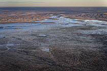Aerial view of flooded mining infrastructure in the Lake Eyre basin, Tirrawarra Swamp, Gidgealpa, South Australia, Australia. July, 2022.
