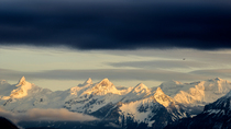 Timelapse of clouds moving over snowcapped mountains at sunset, Lucerne, Switzerland, January 2016.