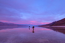 Flooding in the normally dry, Badwater Basin, aftermath of a hurricane. The flooded basin is now called Lake Manly. Early morning light with two photographers witnessing the unusual spectacle, Death V...