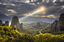 Ray of sunlight breaking through clouds over the monasteries of Meteora, Greece, April 2023.