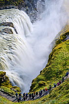 Tourists watching Gullfoss Waterfall on the Hvita River, Iceland. September, 2023.