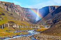 Hengifoss waterfall with rainbow surrounded by basalt cliffs, Hengifoss River, Iceland. September, 2023.