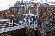 Tourists in open cable lift preparing for descent into Thrihnukagigur volcano, a dormant volcano now used for tours, Iceland. September, 2023. EDITORIAL USE ONLY.