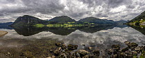 Reflections of clouds and mountains in Lake Jolster (30 km long and 233 m deep), Vestland county, Norway. June, 2021. This lake is part of a fjord that has been isolated after the rising of the landma...