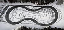 Aerial view of a tyre tracks on a car raceway on frozen lake, Follo, Viken, Norway. January, 2022.
