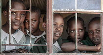 Group of girls looking out of the window in their school, Mara Region, Kenya. September, 2016.