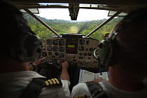 View from inside cockpit of aeroplane coming into land at Kwerba Village airstrip, Foja Mountains, West Papua. November, 2008.