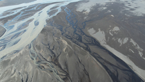 Aerial tracking shot of braided glacial river, south Iceland. June.