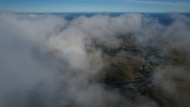 Aerial shot of dry glacier river and 'halo' effect in clouds, south Iceland. June. Sequence 1/2.