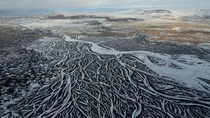 Aerial shot of frozen braided glacial river, south Iceland. February.