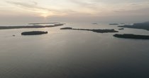 Aerial panning shot of archipelago in late afternoon, Murat LLG, New Ireland, Papua New Guinea.