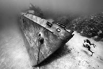 Two divers exploring the bow of the USS Kittiwake wreck (a US Military submarine rescue vessel deliberately sunk as a diving attraction in 2011), Seven Mile Beach, Grand Cayman, Cayman Islands, Caribb...