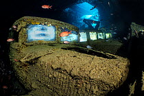 Three Fordson WOT 3 trucks (illuminated by off-camera strobes), surrounded by Red Sea soldierfish (Myripristis murdjan) on the lower level of Hold 2 of the wreck of the SS Thistlegorm. Sha'ab Ali...