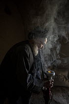 Old man smoking hashish in a traditional Chillum house, Afghanistan. October, 2023.