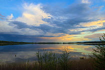 Sunset and a cloudy sky over Rederang lake, Muritz National Park, Mecklenburg-Western Pomerania, Germany. May, 2021.