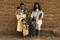 Jose Alberto Simungama and his family holding saplings that will be planted as part of the reforestation project, Sierra Nevada de Santa Marta, Colombia. December, 2021.