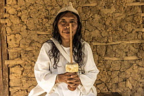 The "mamo" (spiritual leader) of Encanto village, with his poporo, used for chewing of coca leaves. Sierra Nevada de Santa Marta, Colombia. December, 2021.
