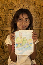 A young girl in Encanto showing a drawing of the ecosystem of Sierra Nevada de Santa Marta, Colombia. December, 2021.