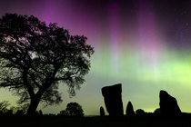 Aurora borealis in night sky at the Grey Ladies stone circle / Nine Stone Close stone circle, Peak District National Park, Derbyshire, England, UK. 10th May 2024.