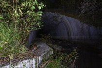 Nutria (Myocastor coypus) using a wildlife underpass below the A89 highway and above the Deirot river at night, Correze, France. October. Camera trap image.