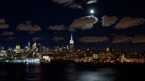 Timelapse of moonrise, looking across the Hudson River at the Empire State Building and Midtown Manhattan,  New York, USA.