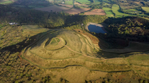 Aerial tracking shot of British Camp Hill Fort, Malvern Hills AONB, Herefordshire and Worcestershire, UK.