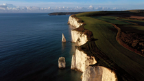 Drone tracking shot of Old Harry Rocks, The Foreland or Handfast Point, Studland, Isle of Purbeck, Dorset, UK.