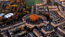 Aerial tracking shot of The Circus and Royal Cresent, Georgian city of Bath, Somerset, UK.